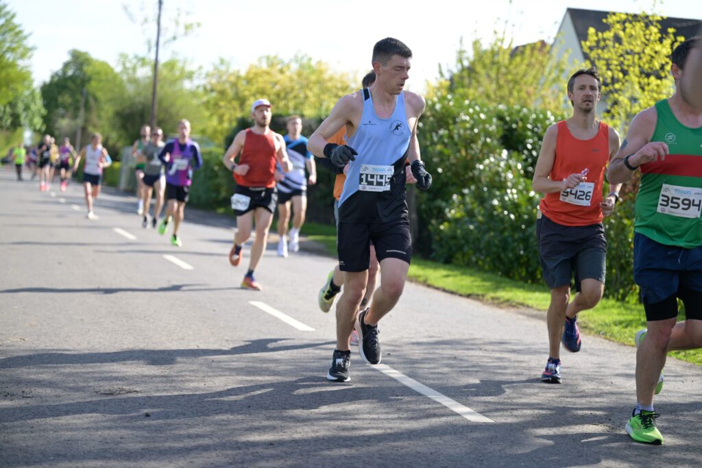 Staggered runners in the early miles of the half marathon race